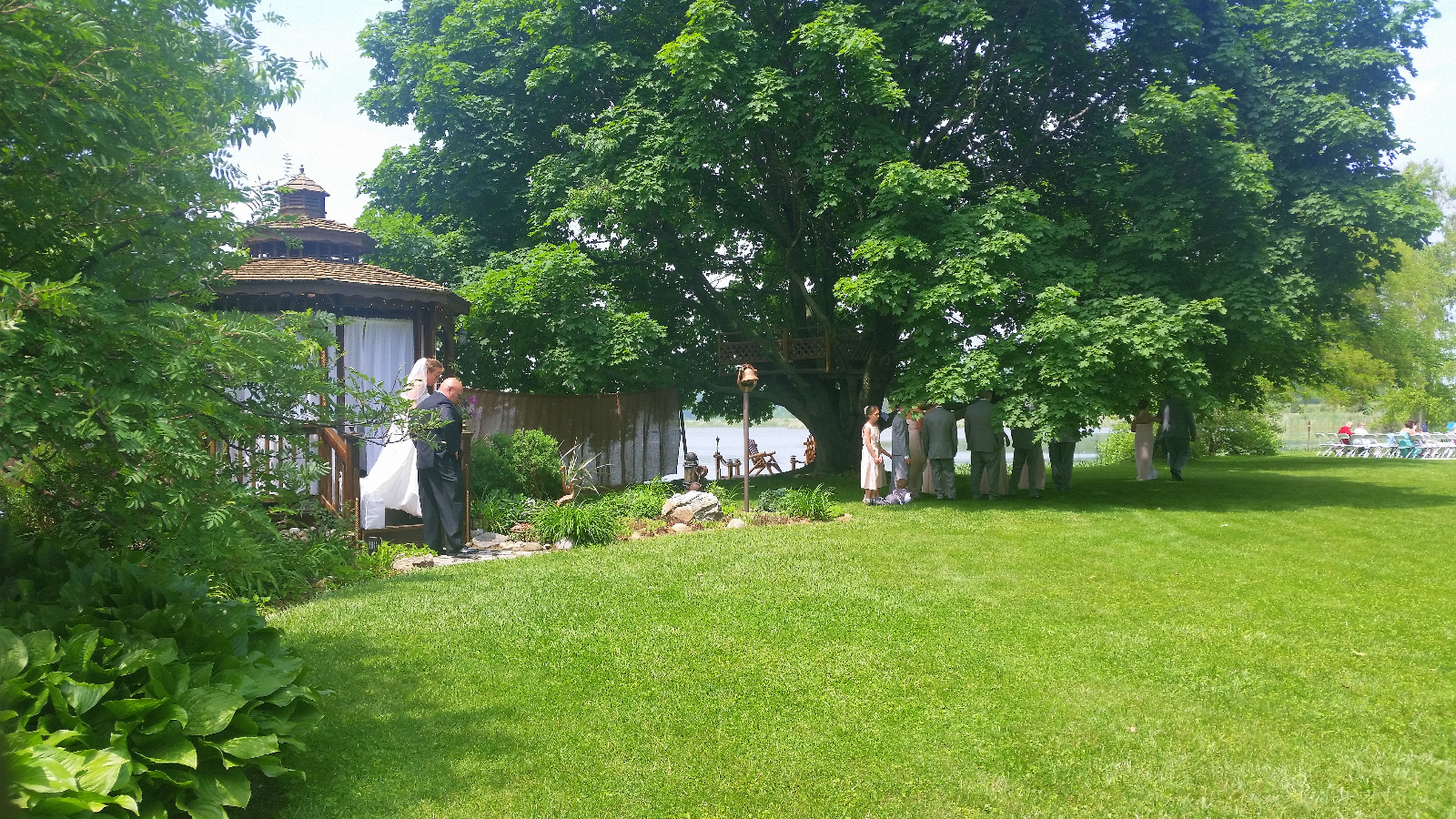 Here the Bride is exiting the curtained Cedar Gazebo to meet her father for their walk to the Ceremony